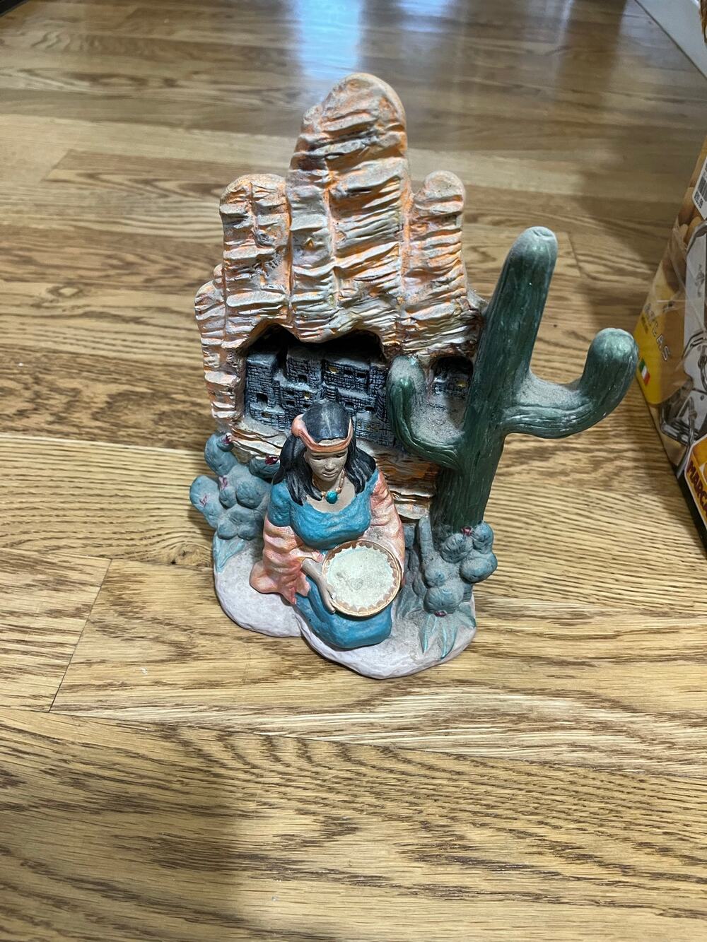 Southwestern-style resin figurine featuring a kneeling woman